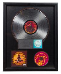 A Kanye West: The College Dropout RIAA Certified 2x Platinum Presentation Album 21 1/2 x 17 1/2 inches.