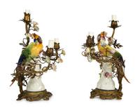 A Near Pair of French Porcelain, Gilt Bronze and Tole Lamps Mounted with Porcelain Parrots — LATE 19TH/EARLY 20TH CENTURY