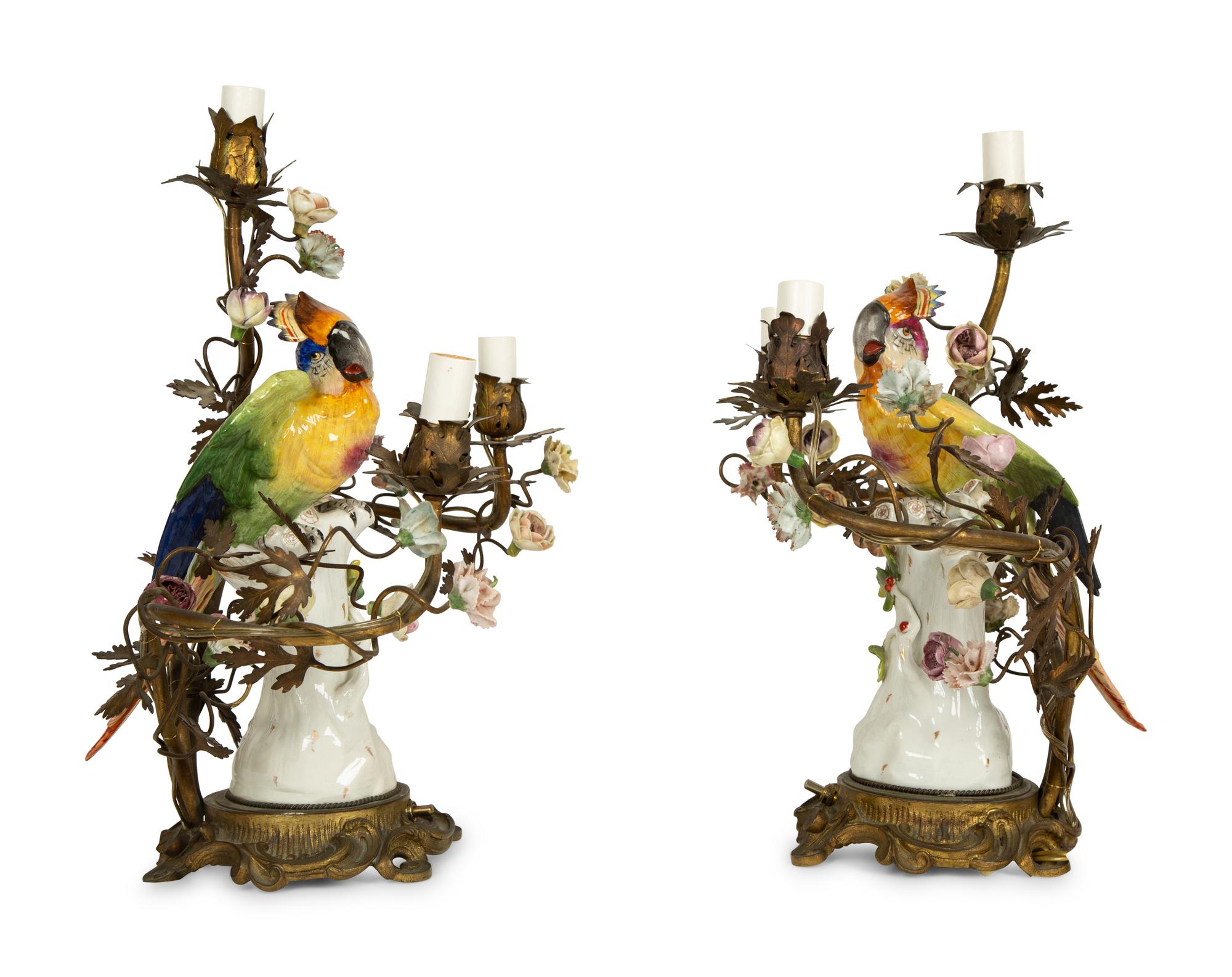A Near Pair of French Porcelain, Gilt Bronze and Tole Lamps Mounted with Porcelain Parrots — LATE 19TH/EARLY 20TH CENTURY