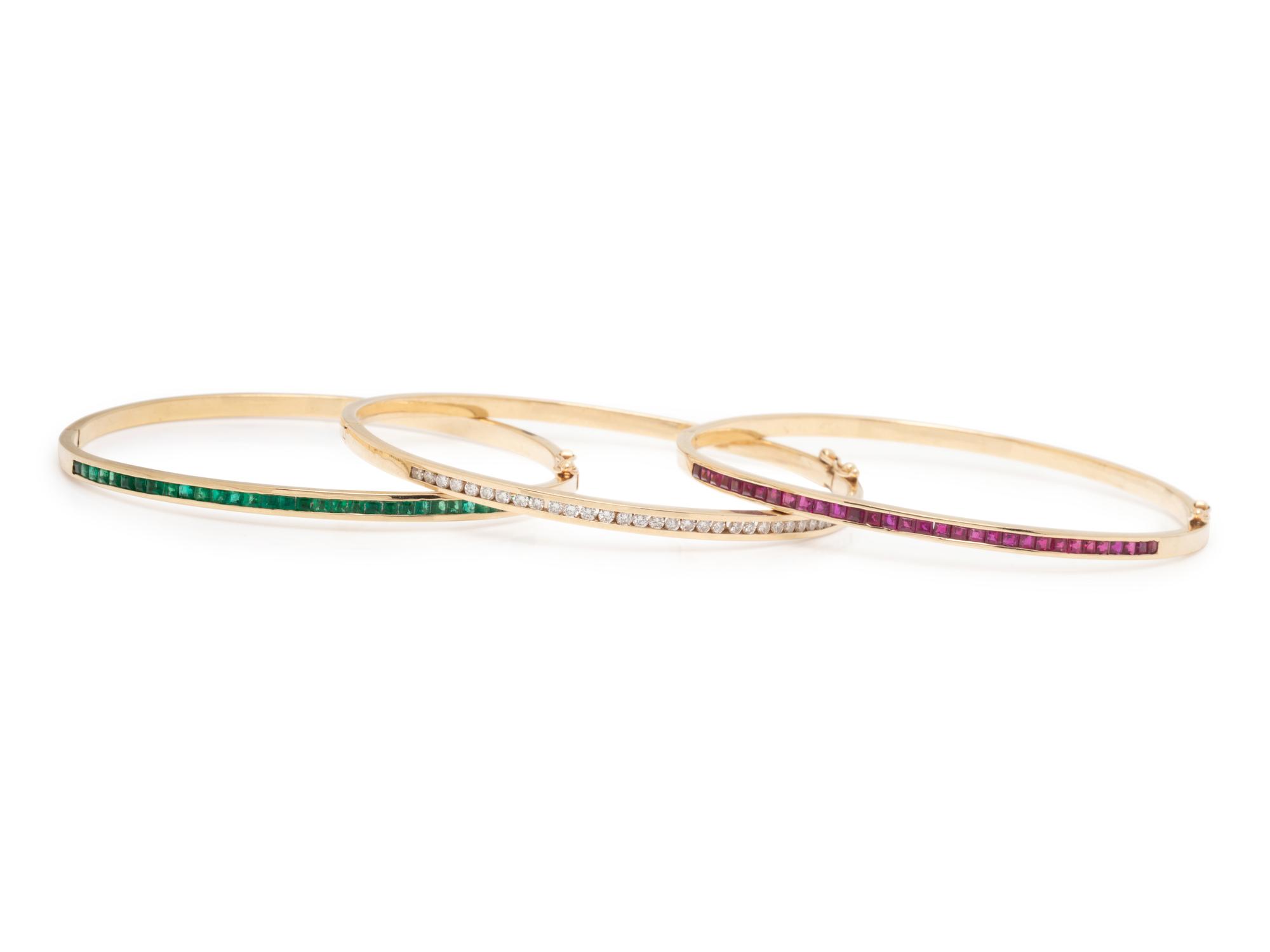 COLLECTION OF RUBY, DIAMOND, AND EMERALD BANGLE BRACELETS