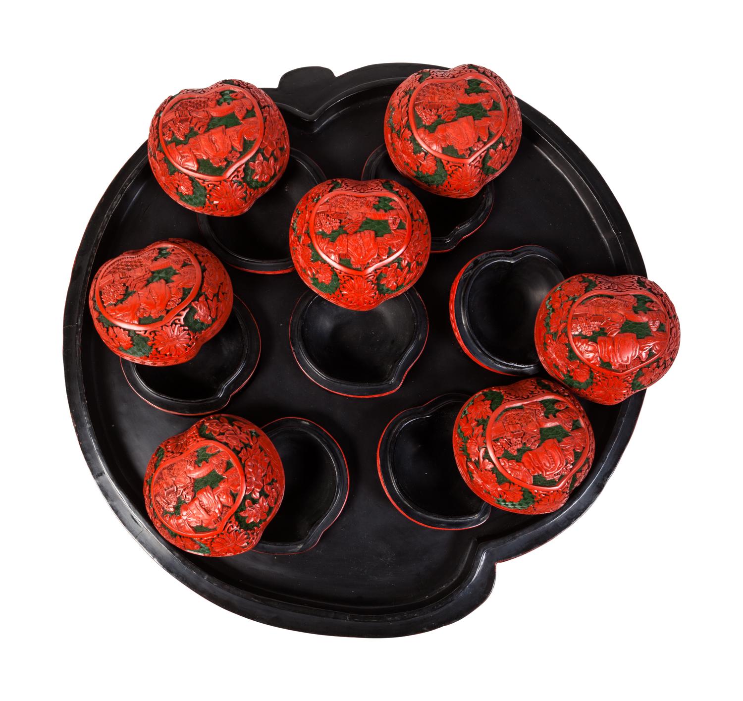 A Set of Chinese Export Carved Red Lacquer "Peach" Nesting Boxes and a Stand