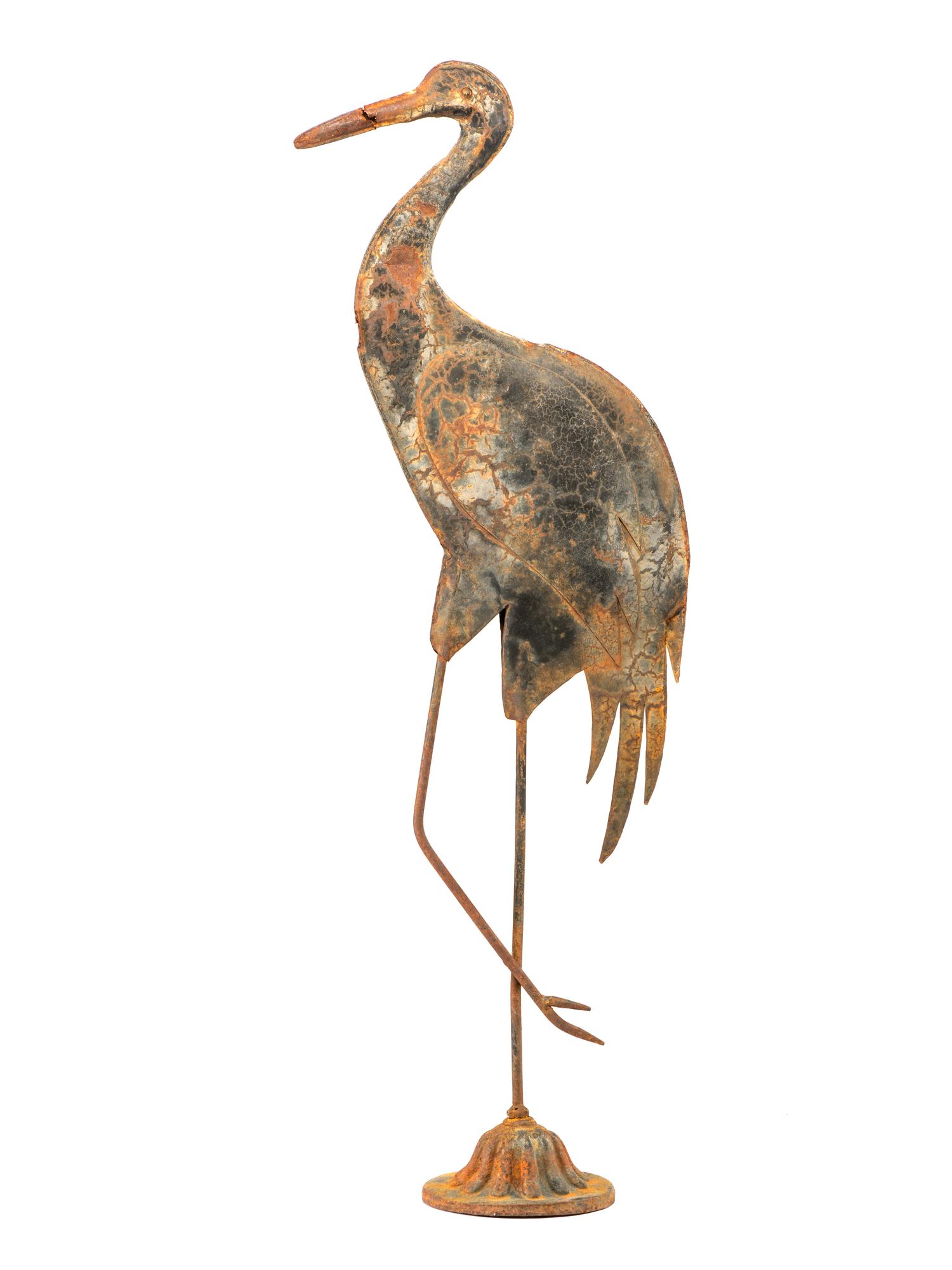 A Cast Iron and Tin Rooster Weathervane and Tin Heron