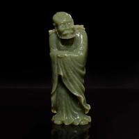 A Chinese carved celadon jade figure of a Lohan 青玉雕羅漢