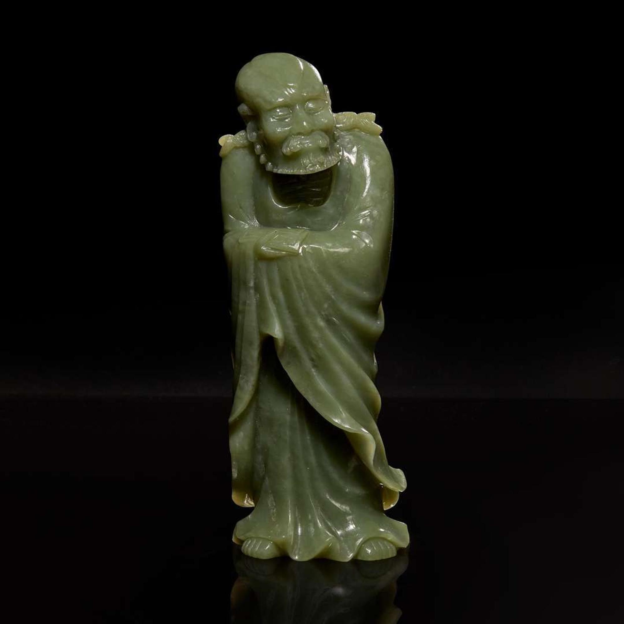 A Chinese carved celadon jade figure of a Lohan 青玉雕羅漢