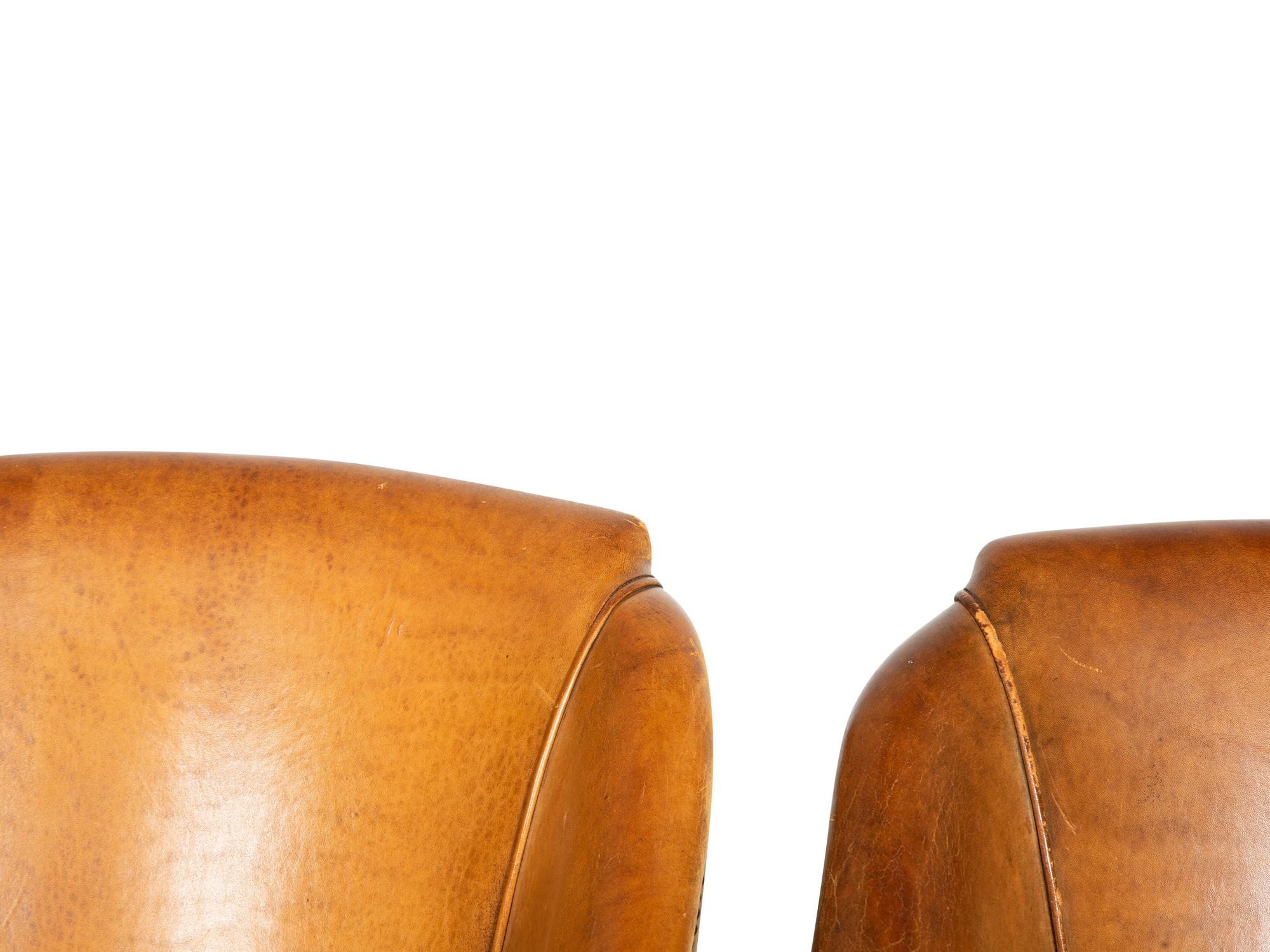 A Set of Four Leather-Upholstered Barrel-Back Armchairs