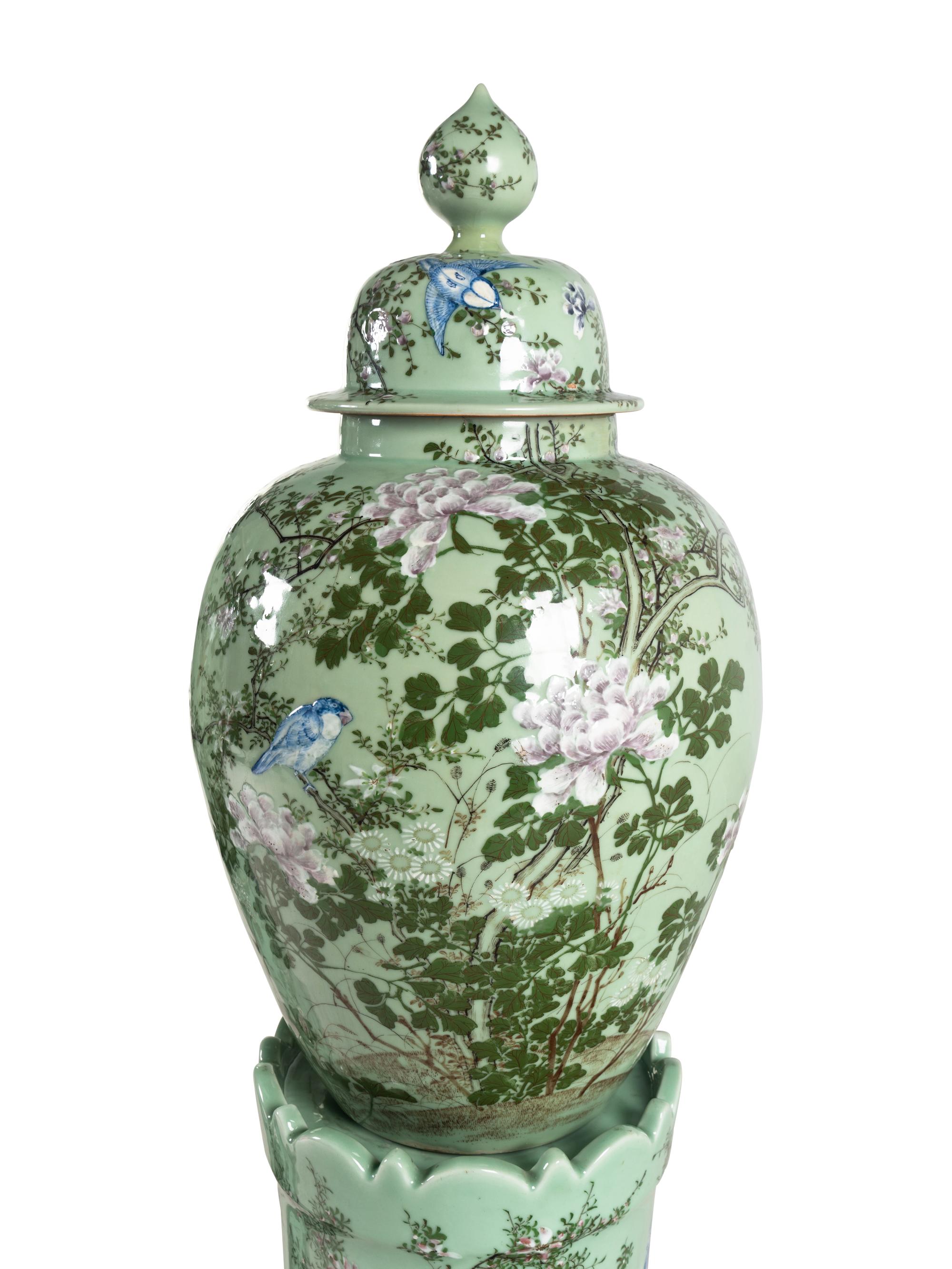 A Pair of Chinese Large Porcelain Covered Urns on Pedestals