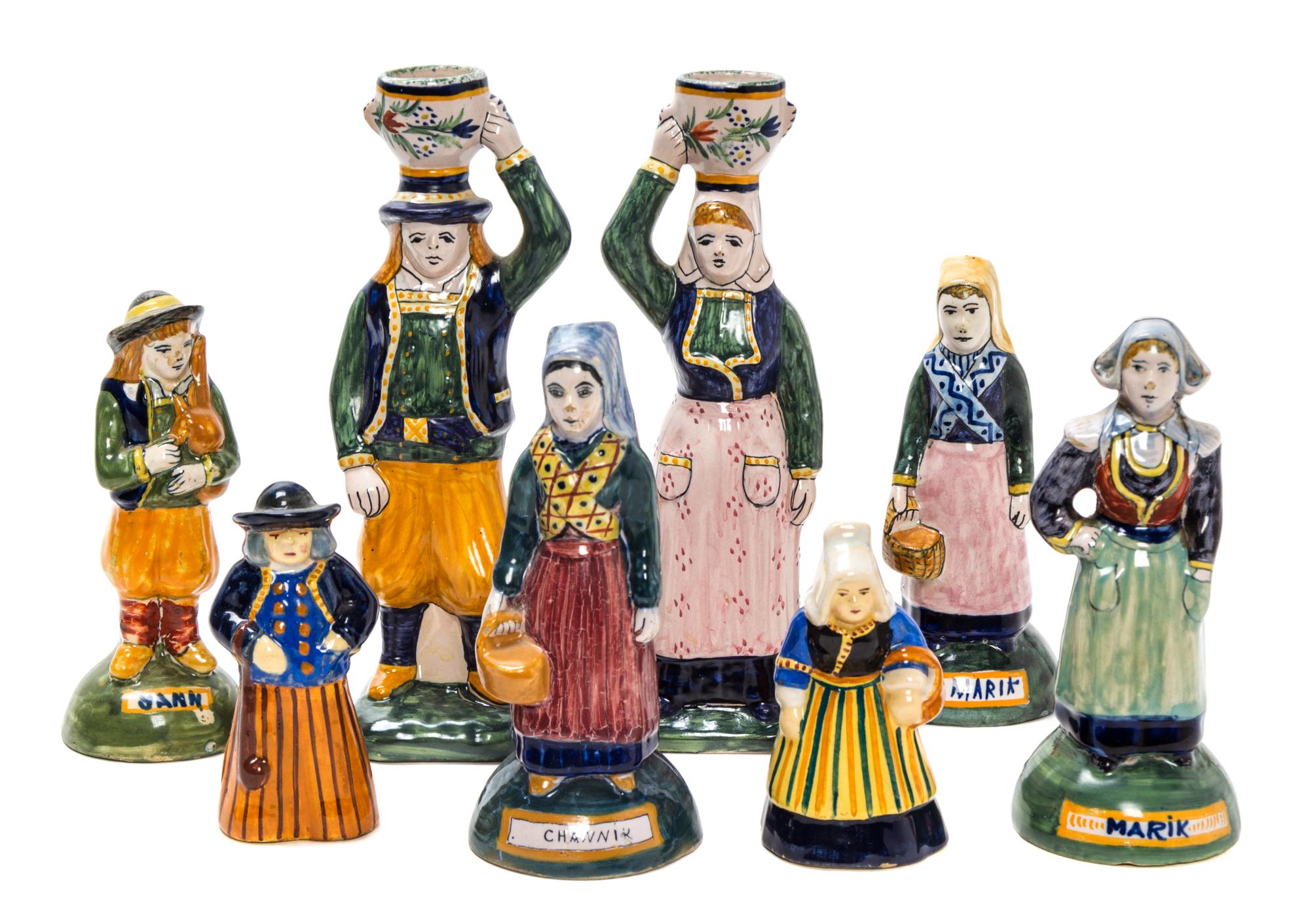 A Collection of Eight Quimper Pottery Figures Height of tallest 8 inches.
