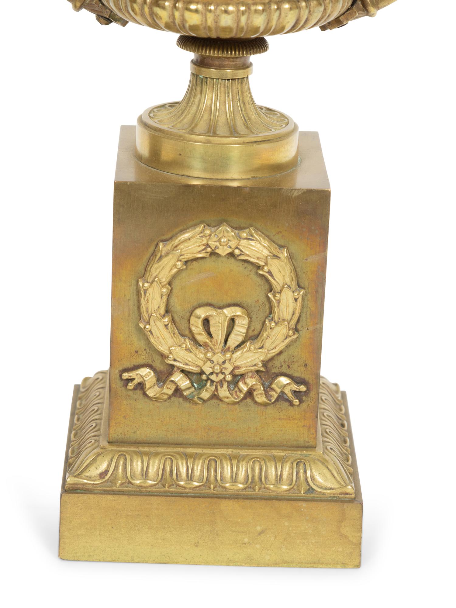 A Pair of Empire Gilt Bronze Urns on Pedestal Bases