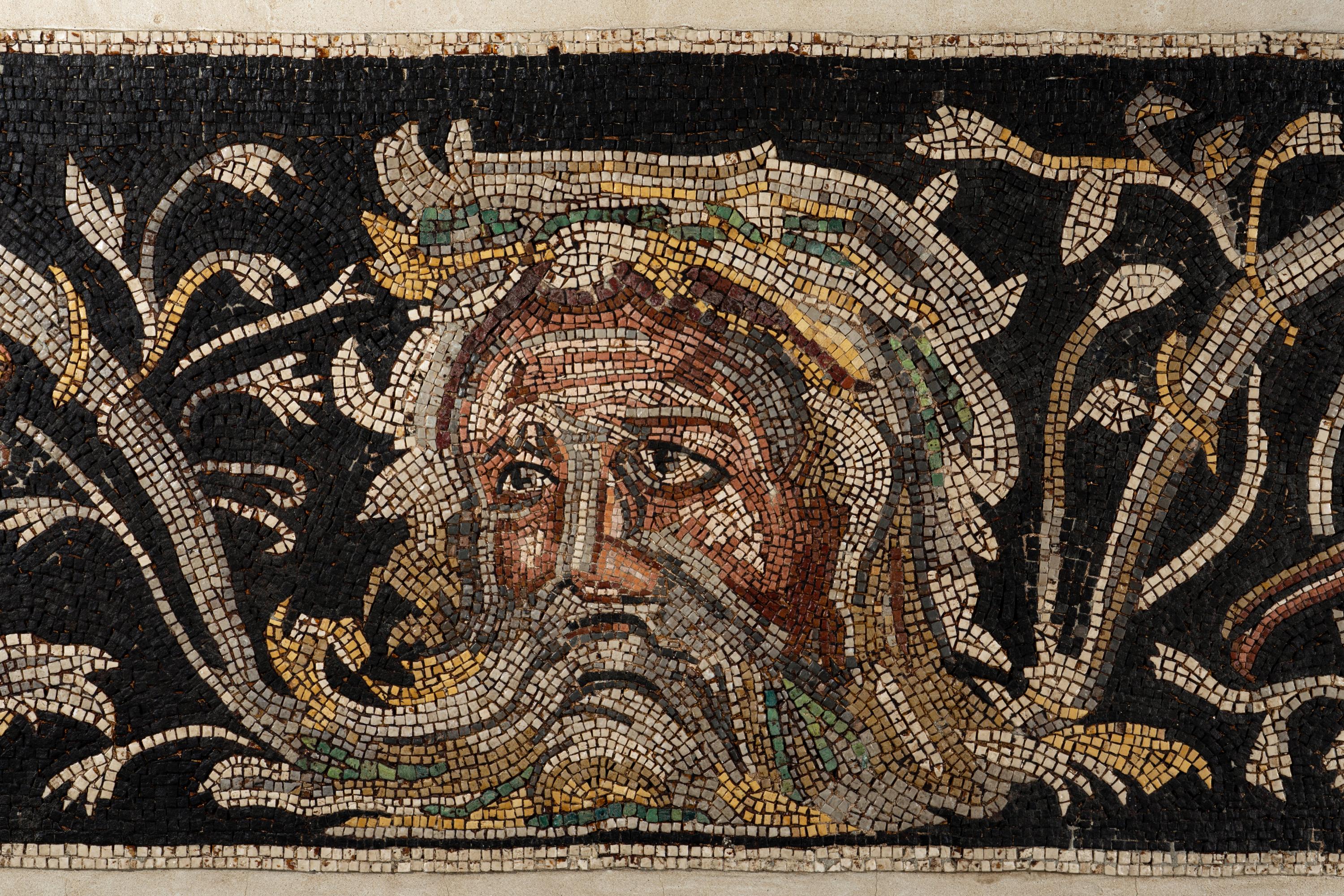 A Roman-Style Polychrome Mosaic Panel with a Bearded Head and Two Animals