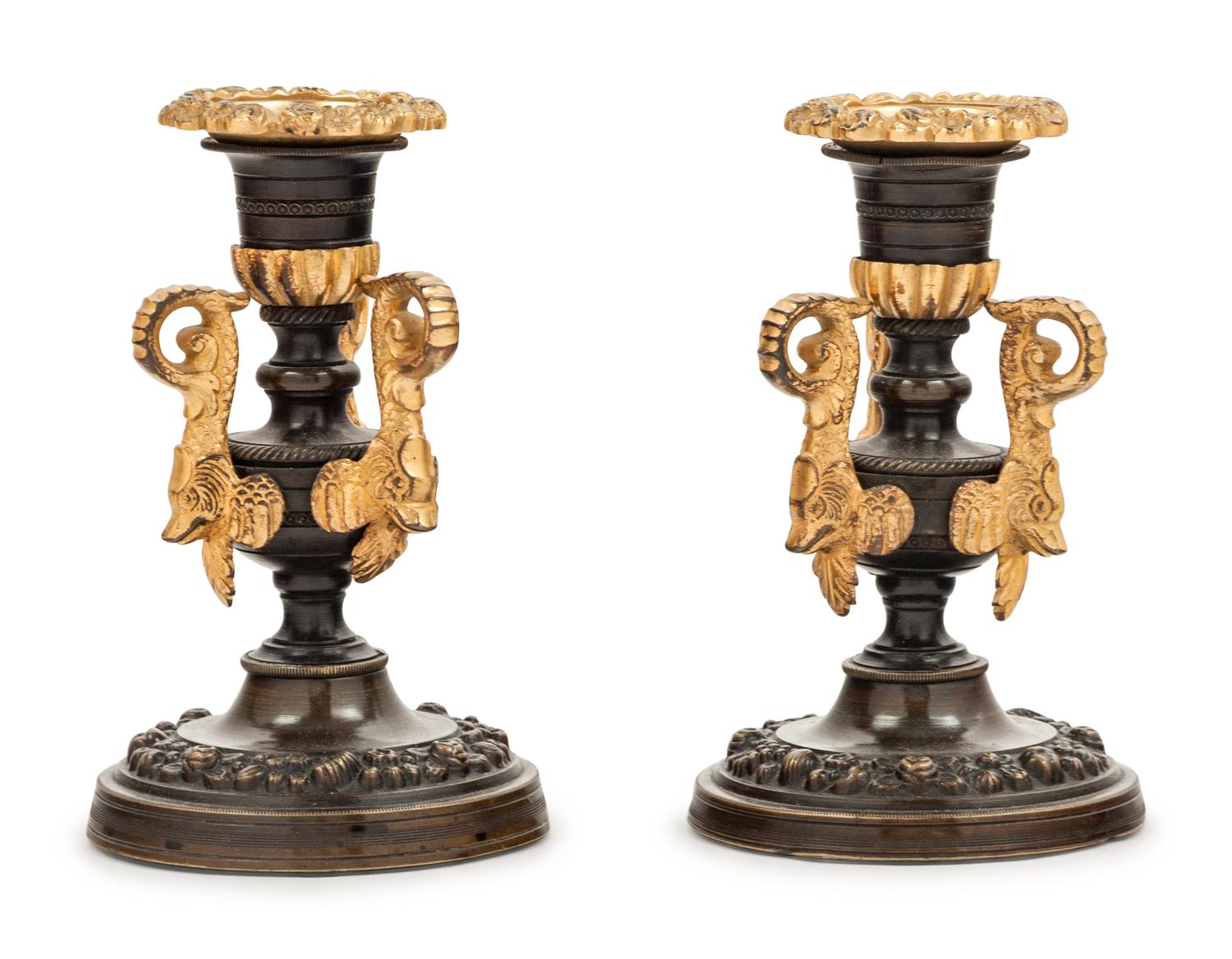 A Pair of Patinated and Gilt Bronze Candlesticks