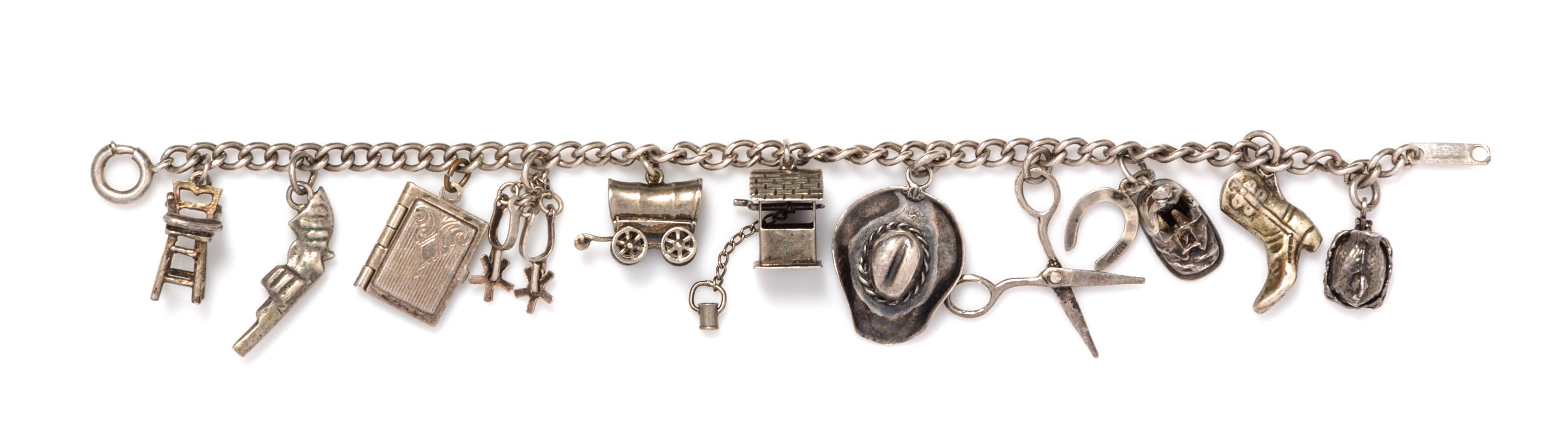 A Sterling Silver Charm Bracelet with 11 Attached Sterling Silver and Base Metal Articulated Charms, 13.40 dwts.