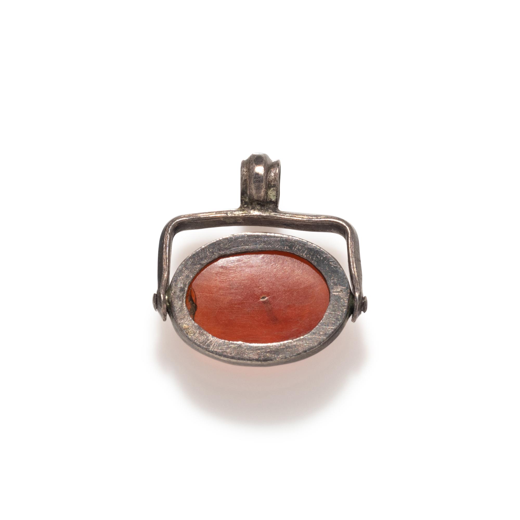 A Roman Carnelian Scaraboid with a Muse — Set in a silver swivel pendant