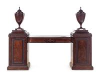 An Edwardian Carved and Figured Mahogany Double Pedestal Sideboard and a Pair of Urn-Form Cutlery Boxes