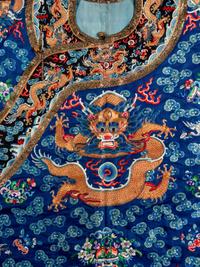 A Chinese Blue Ground Embroidered Silk Dragon Robe, Jifu, Late 19th Century 清晚期 藍緞地綉云龍紋吉服