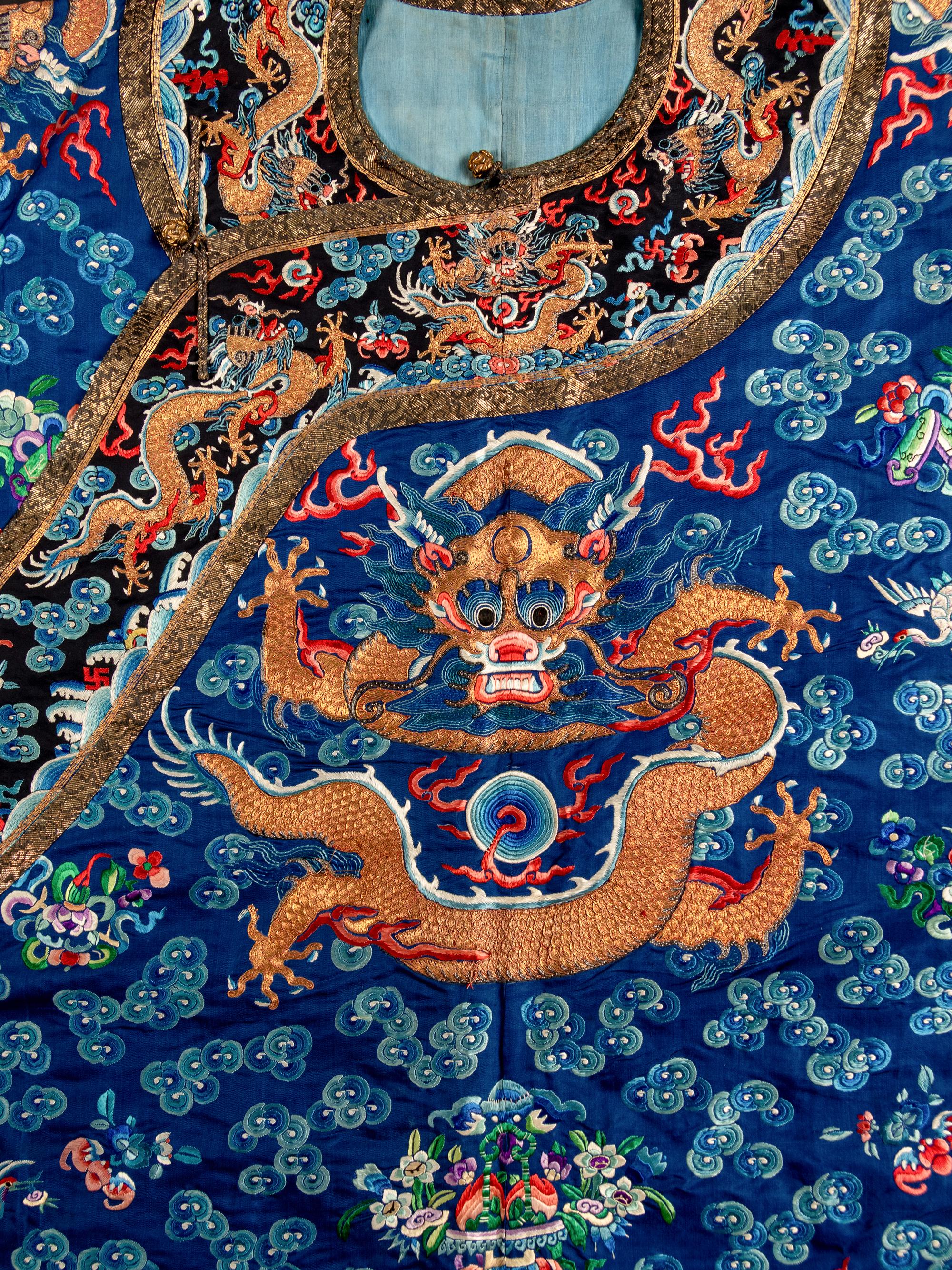 A Chinese Blue Ground Embroidered Silk Dragon Robe, Jifu, Late 19th Century 清晚期 藍緞地綉云龍紋吉服