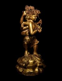 A Chinese Gilt Lacquered Wood Figure of a Deity