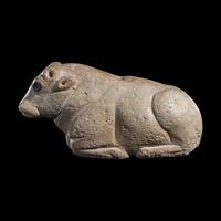 A Mesopotamian Limestone Recumbent Bull with Lapis Lazuli Inlays