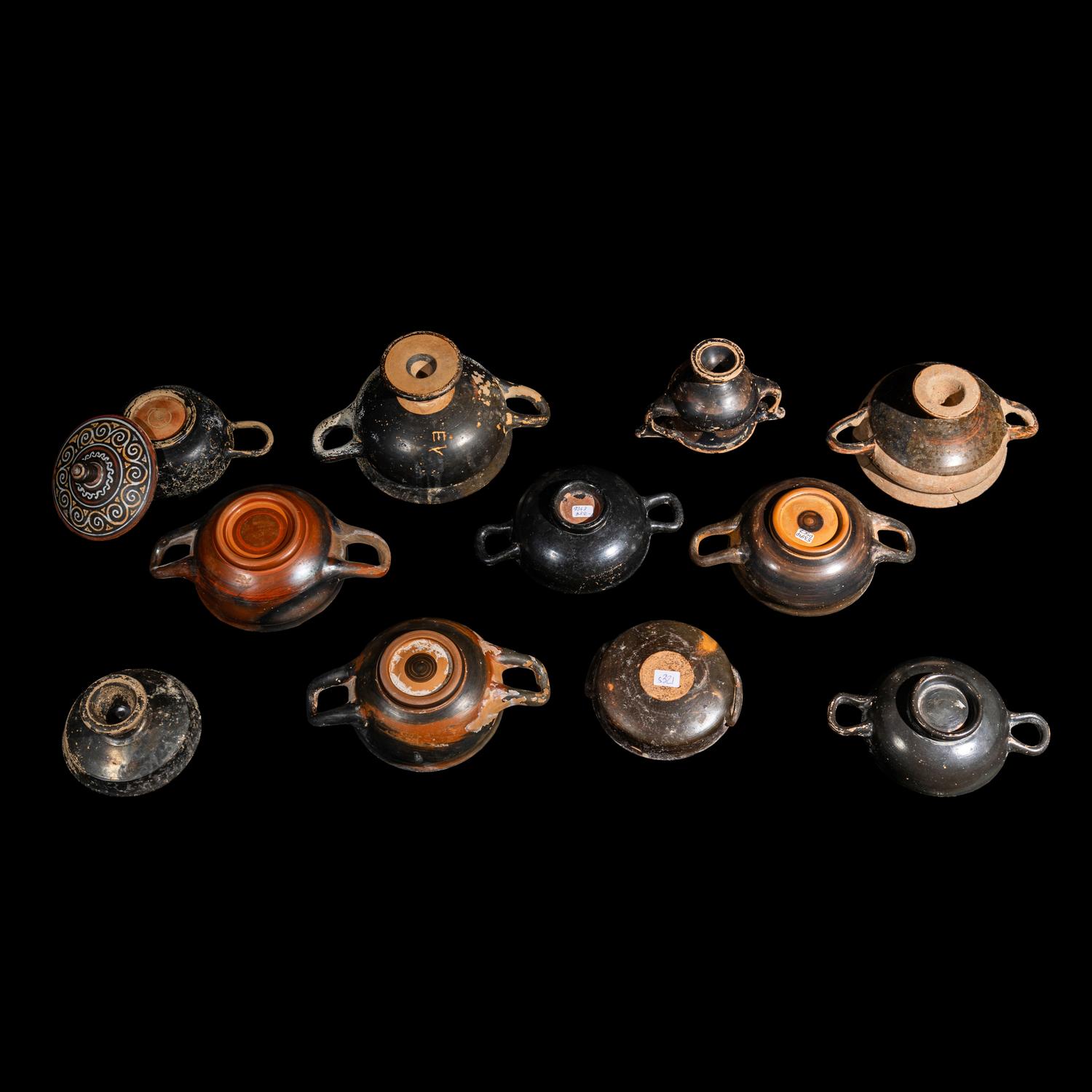 Eleven Greek Black-Glazed Vessels and Lids