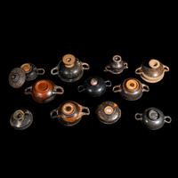 Eleven Greek Black-Glazed Vessels and Lids