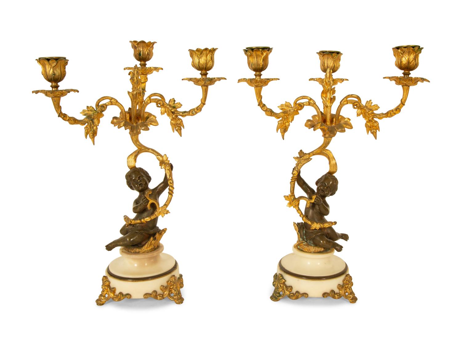 A Pair of Gilt and Patinated Bronze Figural Three-Light Candelabra