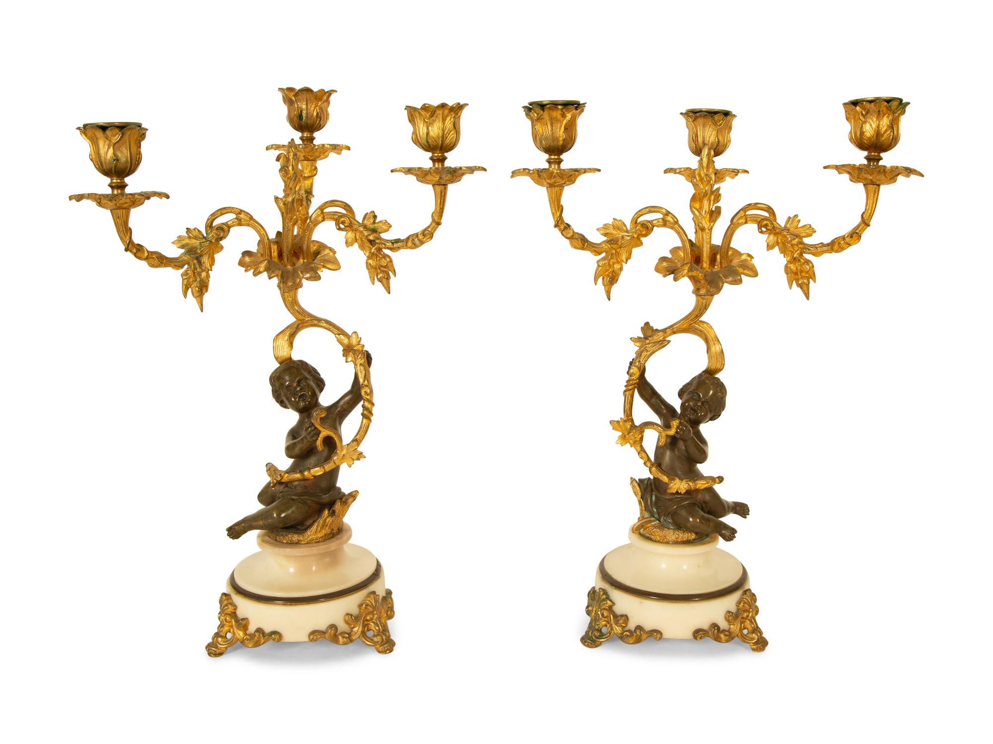 A Pair of Gilt and Patinated Bronze Figural Three-Light Candelabra