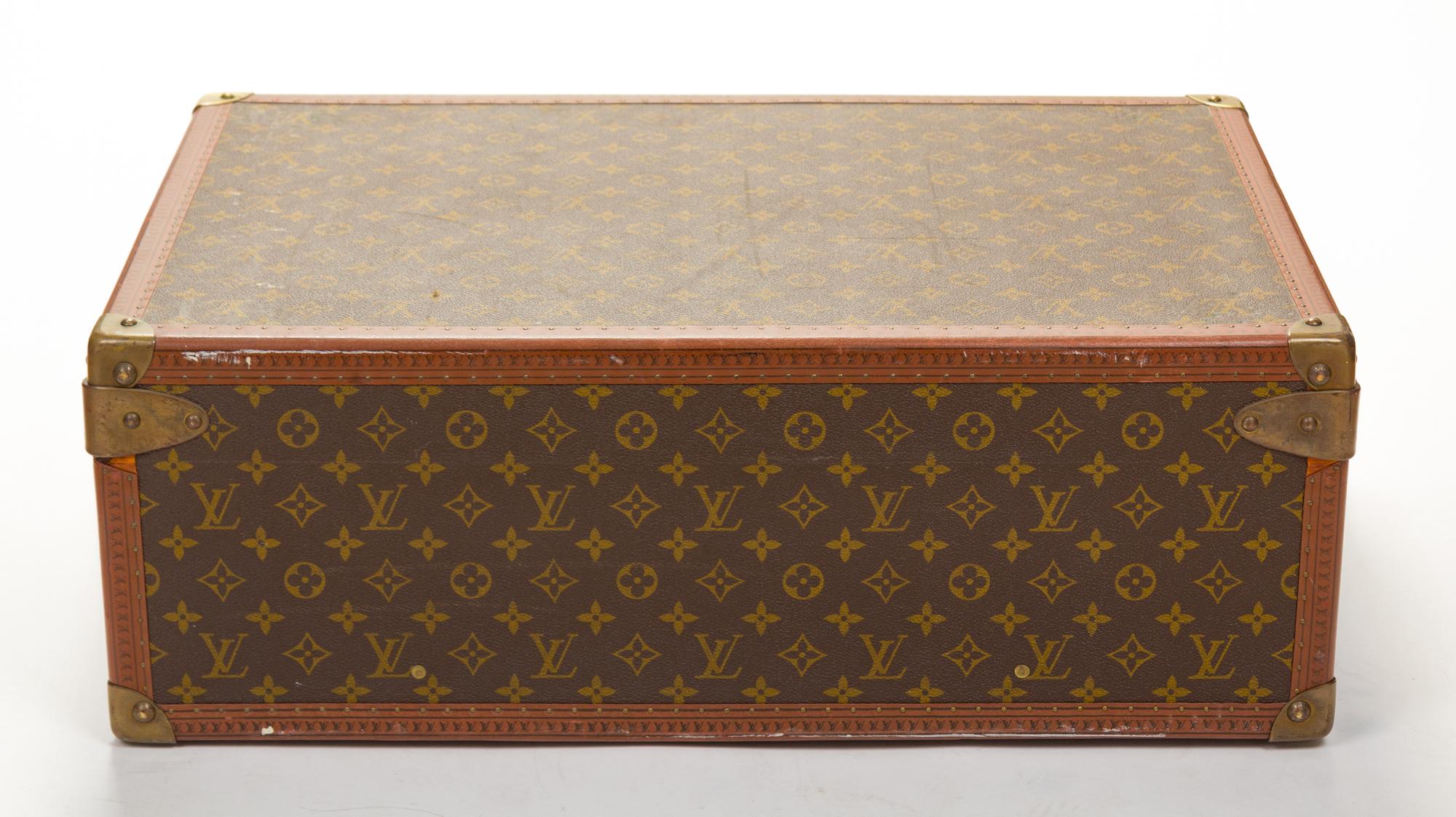 A Louis Vuitton Monogram Canvas Alzer Suitcase, 16" H x 23.5"W x 8.25"D; Handle drop: 2".