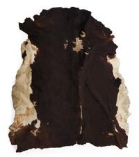 Three Native Tanned Hides Length of largest approximately 82 x 71 inches.