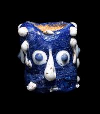 A Phoenician Glass Triple-Face Bead