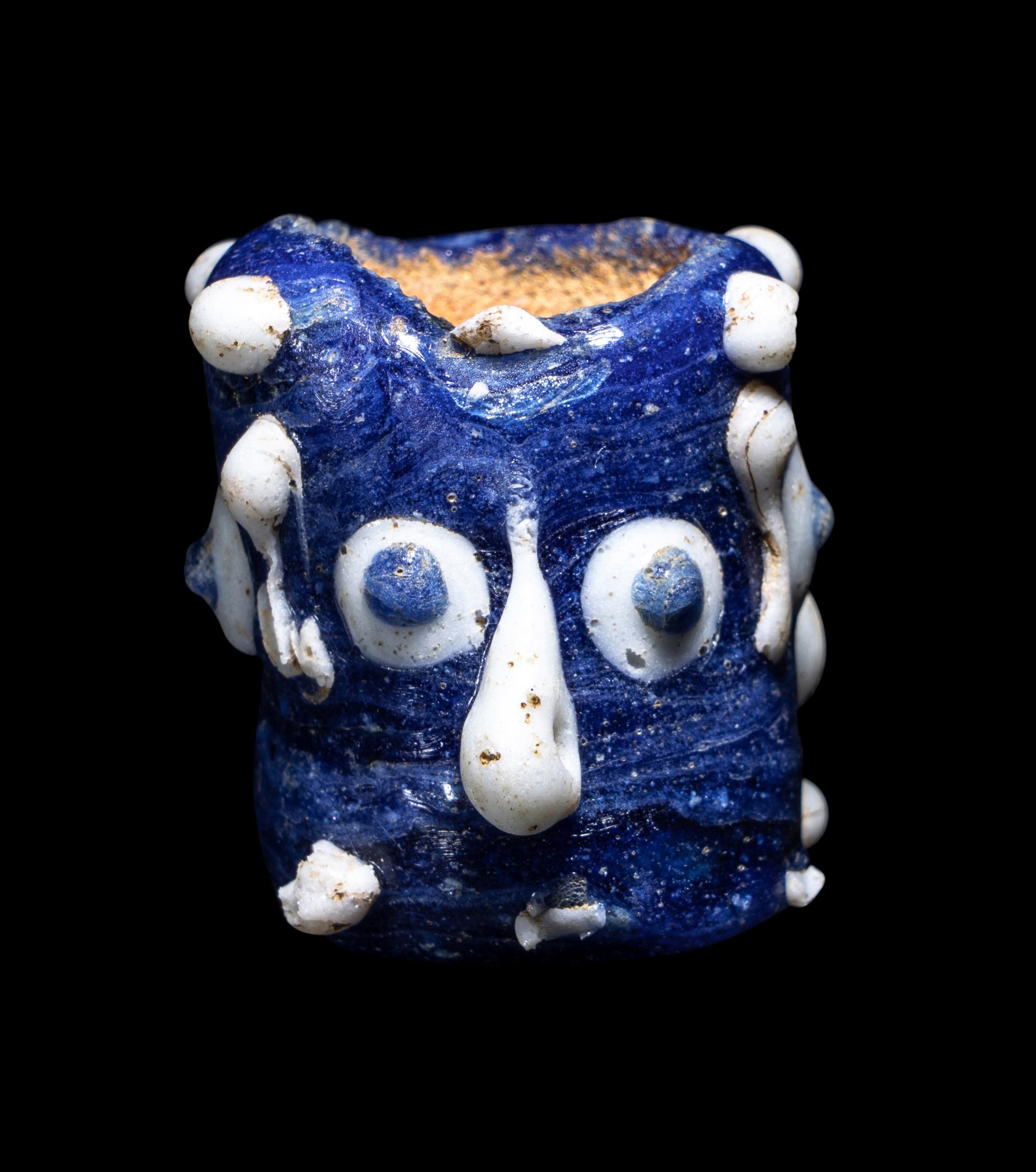A Phoenician Glass Triple-Face Bead