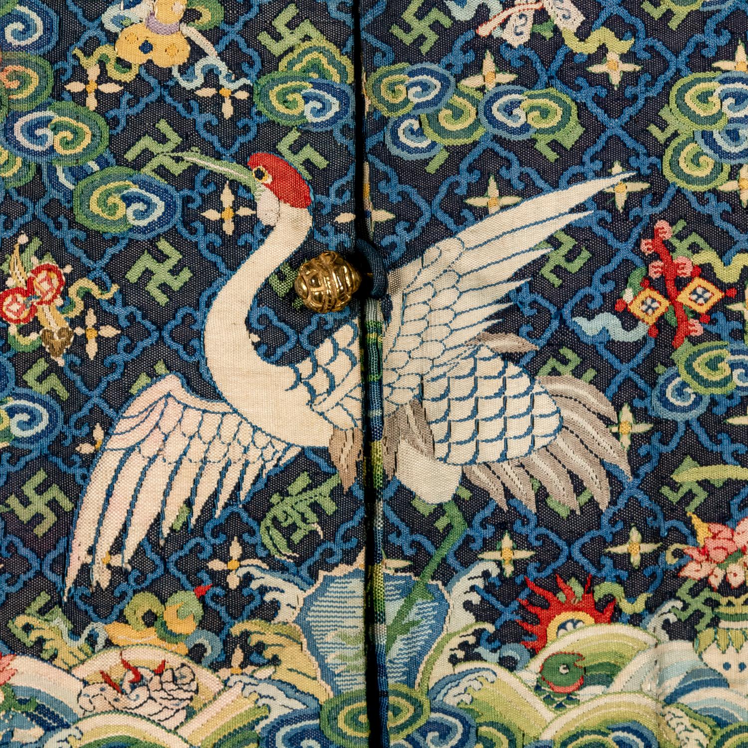 A Chinese Navy Blue Ground Official's Surcoat, Bufu, and A Velvet-Brimmed Winter Hat, Jiguan, 19th Century 清中晚期 藍地一品文官補服及冬吉冠一頂