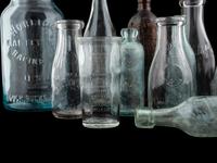 Sixteen Glass Advertising Bottles