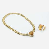 An 18K yellow gold and citrine necklace and topaz ring