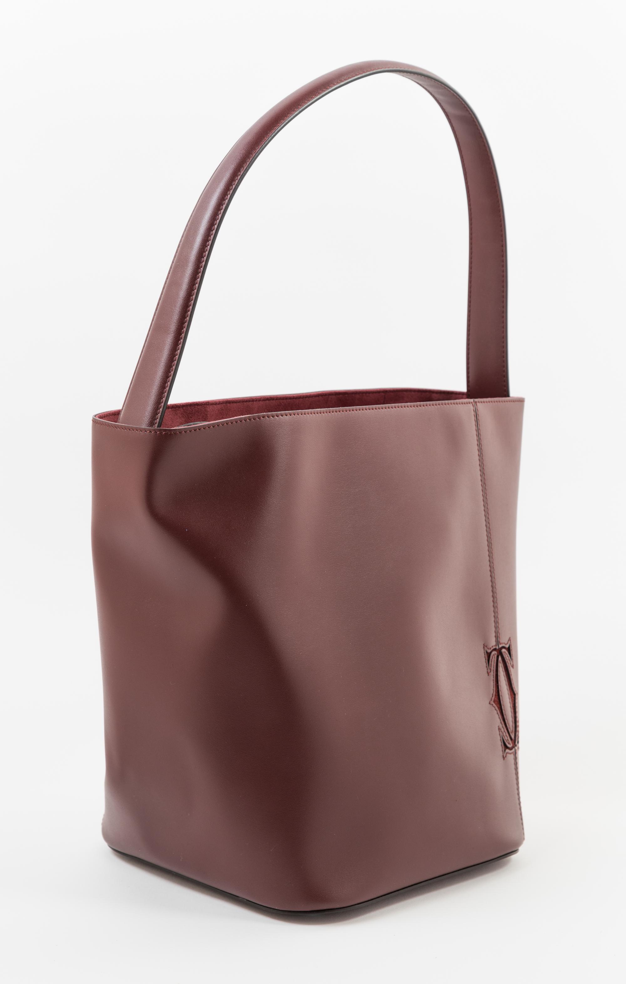 A Cartier Burgundy Calfskin Must-C Bucket Bag, 8" x 11" x 7.5"; Handle drop: 9".