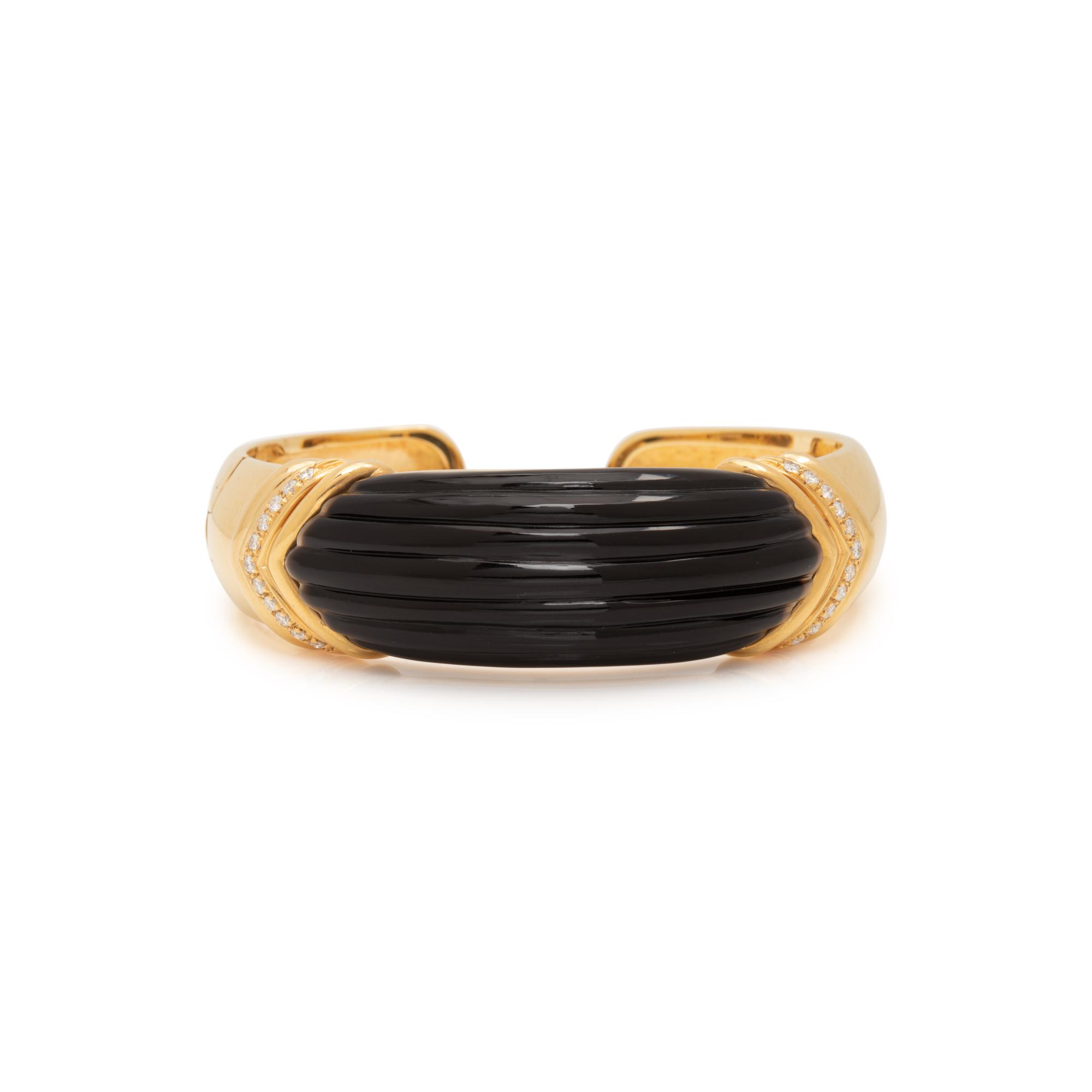 YELLOW GOLD, ONYX AND DIAMOND CUFF BRACELET