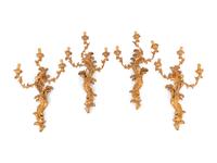 A Set of Four Italian Carved Giltwood Three-Light Sconces