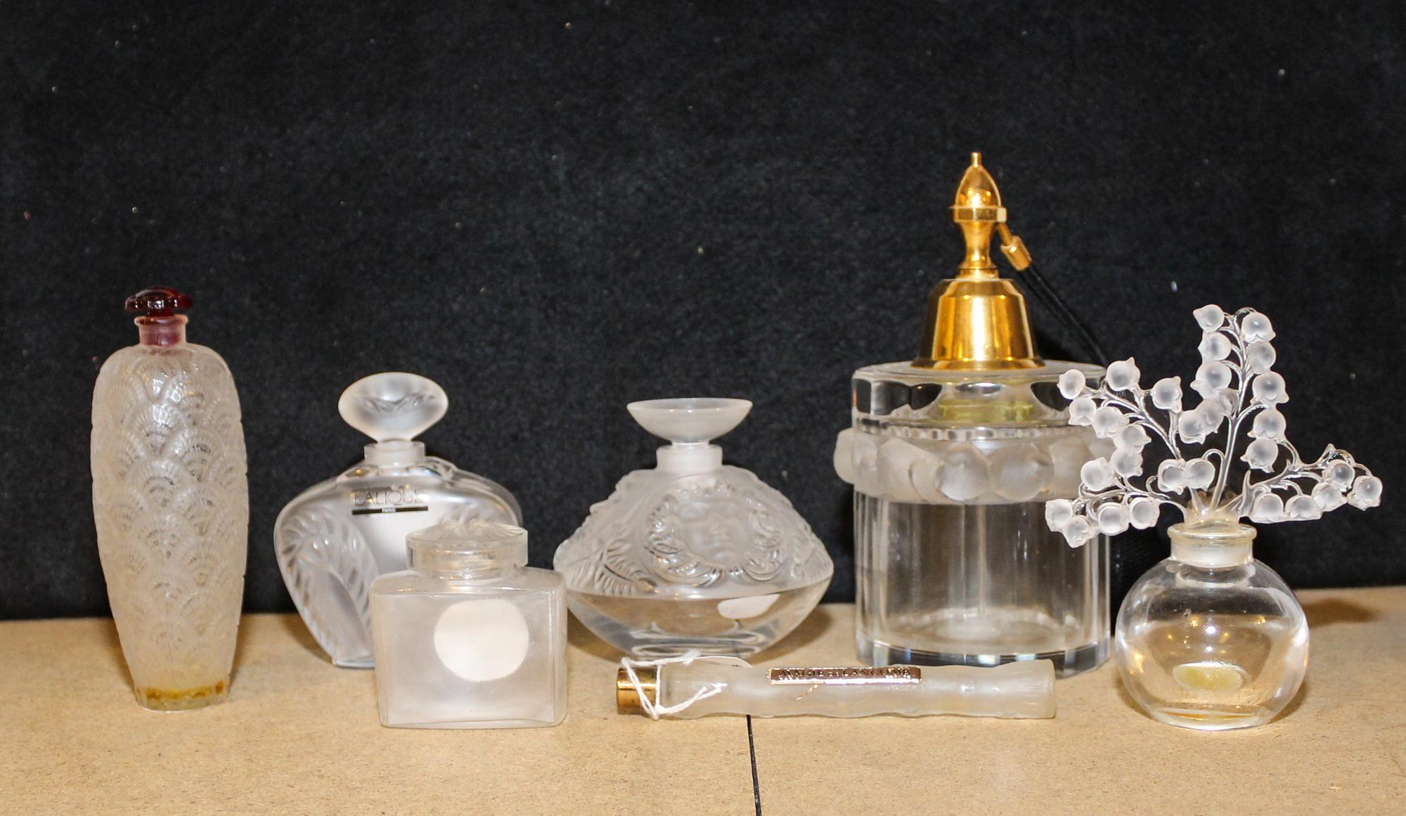 Seven French Molded and Frosted Glass Perfume Articles Height of atomizer 6 3/4 inches.