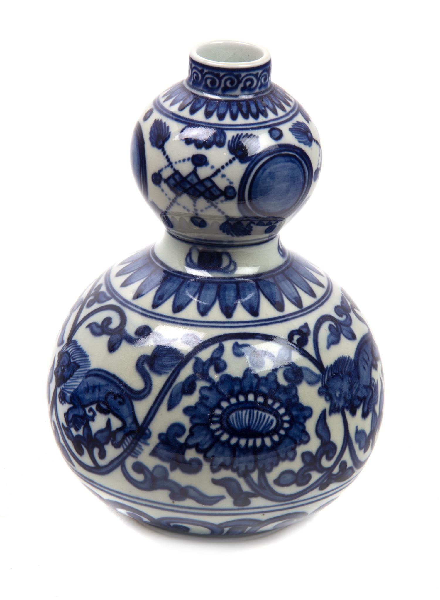 A Chinese Blue and White Porcelain Gourd Form Vase Height 8 1/4 inches.