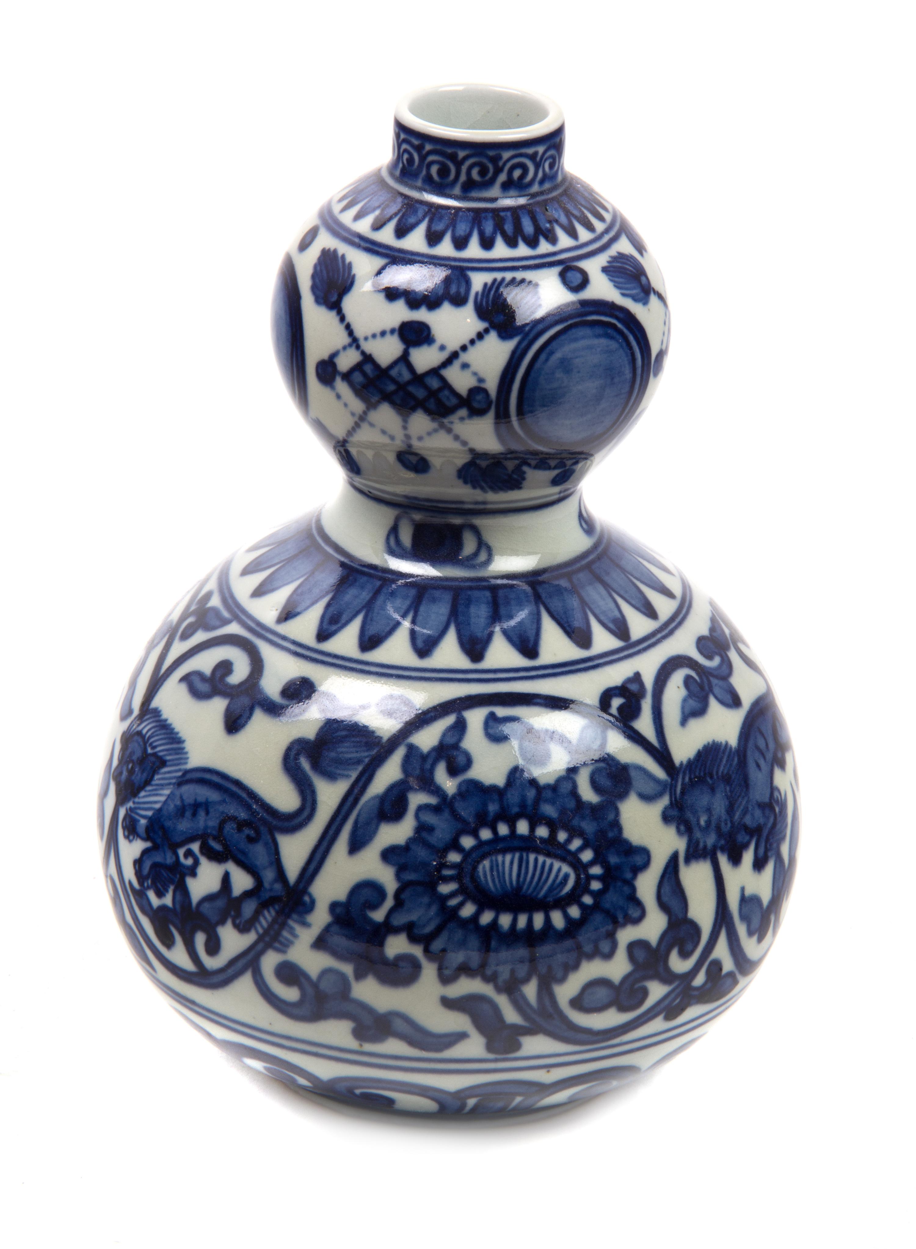 A Chinese Blue and White Porcelain Gourd Form Vase Height 8 1/4 inches.
