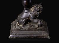 A pair of Chinese lion-form patinated bronze candle sticks, Qing dynasty, possibly Kangxi period 獅形銅加漆燭臺一對 清 可能為康熙