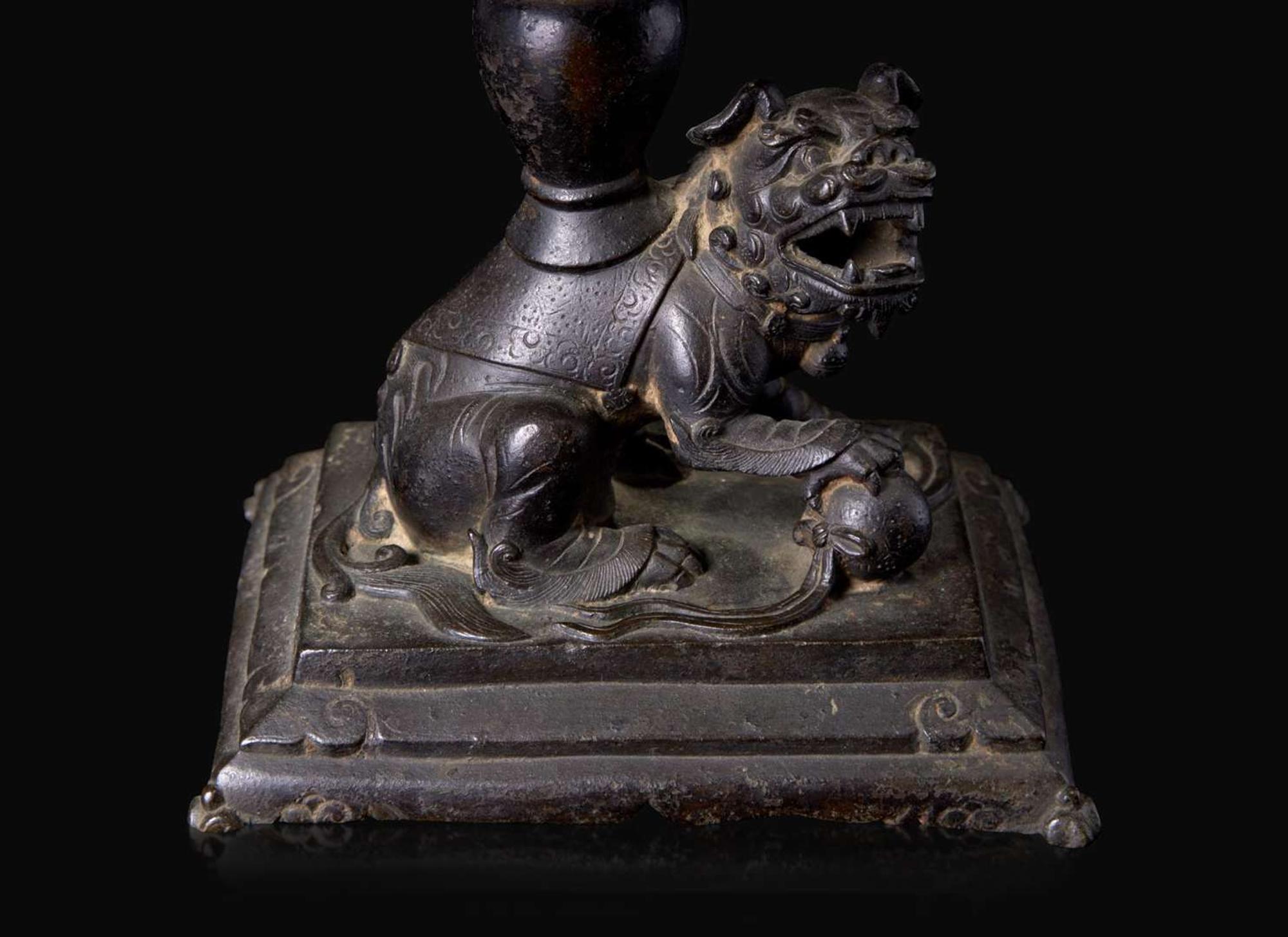 A pair of Chinese lion-form patinated bronze candle sticks, Qing dynasty, possibly Kangxi period 獅形銅加漆燭臺一對 清 可能為康熙