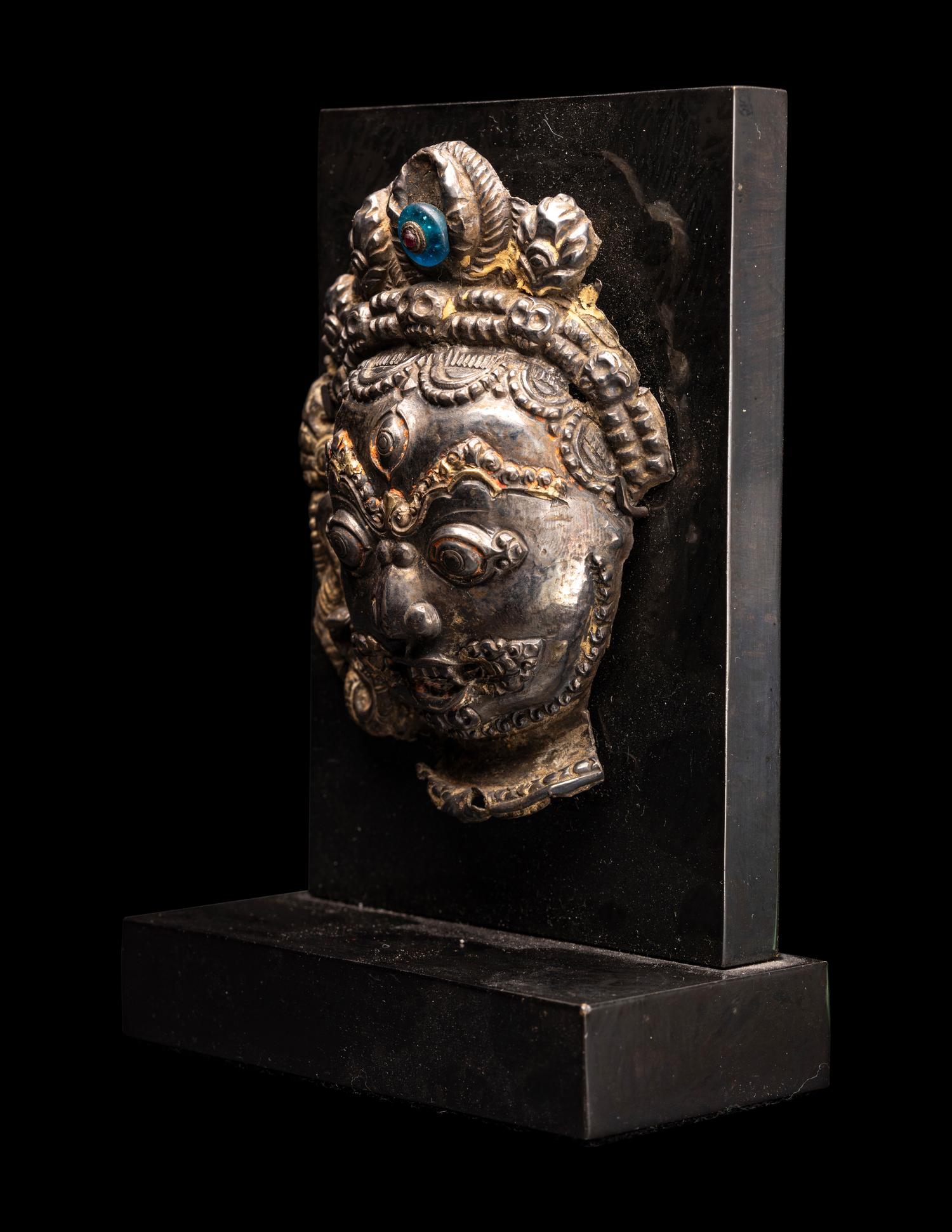 A Nepalese Silvered Metal Repouss é Mask of Bhairava