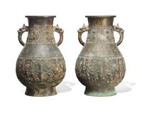 A pair of patinated bronze archaistic large vases