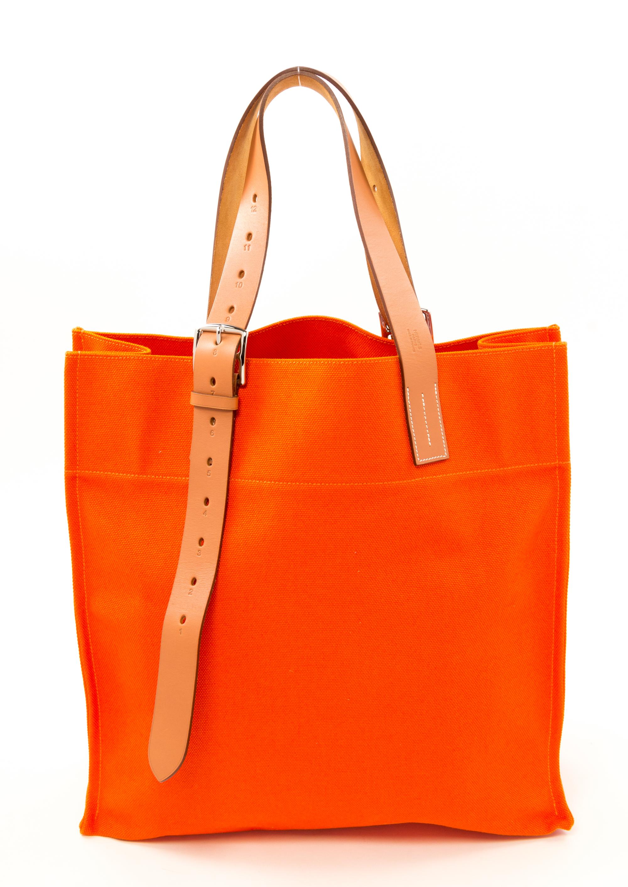 An Hermès Orange Canvas Etiviere Shopping Tote, 16" x 17" x 6"; Strap adjustable to 17".