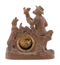 A Continental Terra Cotta Figural Clock
