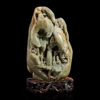 A Large Chinese carved celadon and russet jade mountain and wood stand