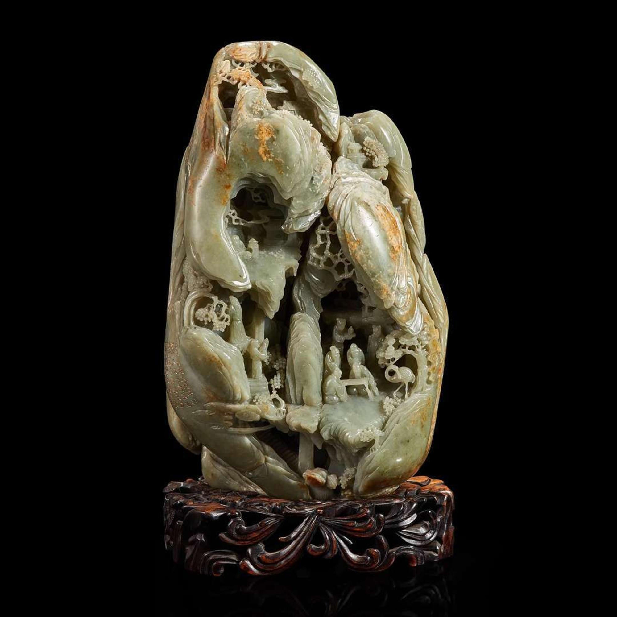 A Large Chinese carved celadon and russet jade mountain and wood stand