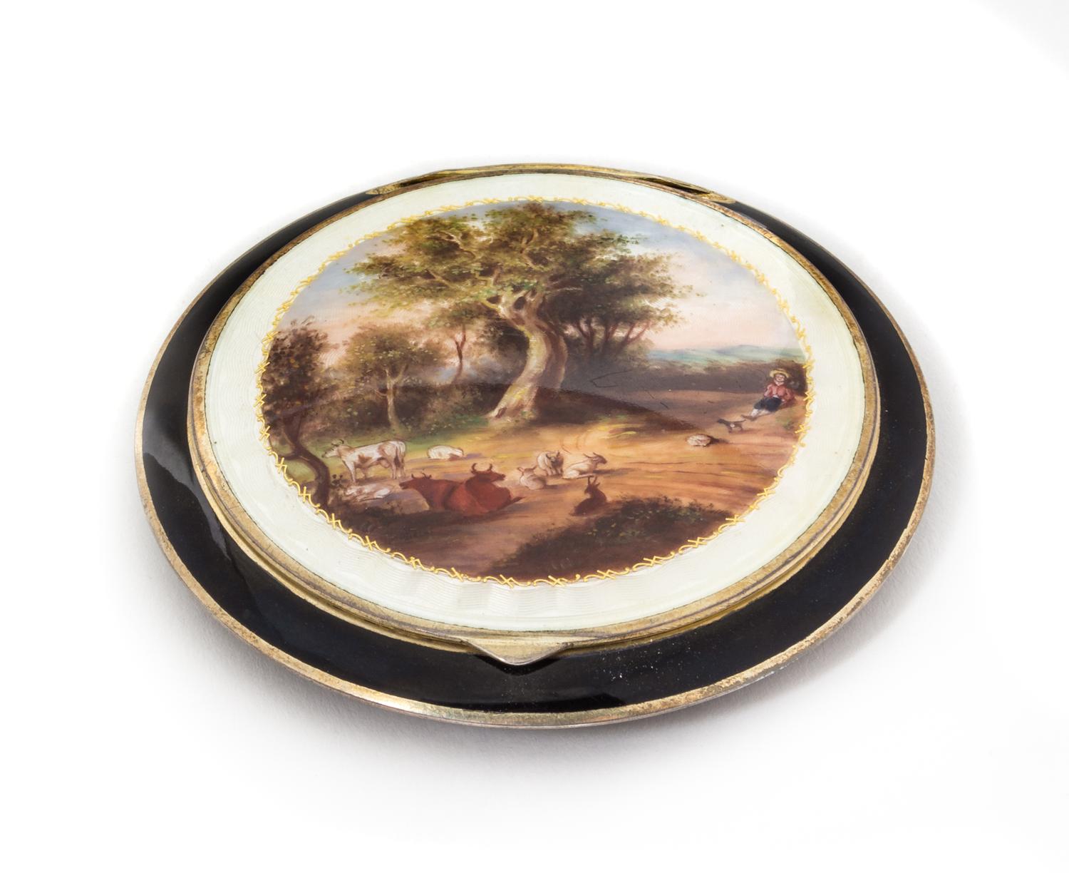 An Austrian Enameled Silver Compact, Vienna, 20th Century, the lid with a guilloche enamel border enclosing a polychrome decorated past