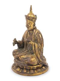 A Tibetan Gilt Bronze Figure of a Seated Guru
