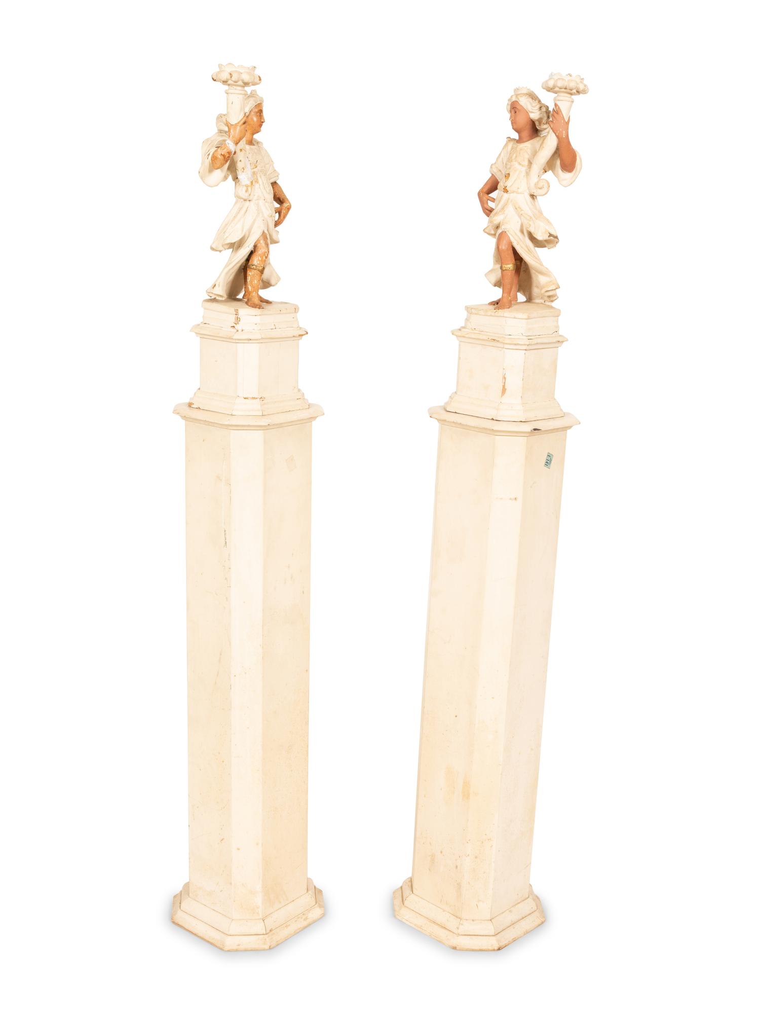A Pair of Italian Painted Figural Candelsticks on Pedestal Bases
