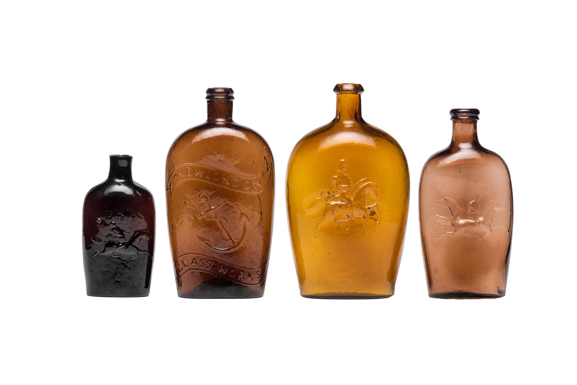 Four Molded Glass Amber Flasks